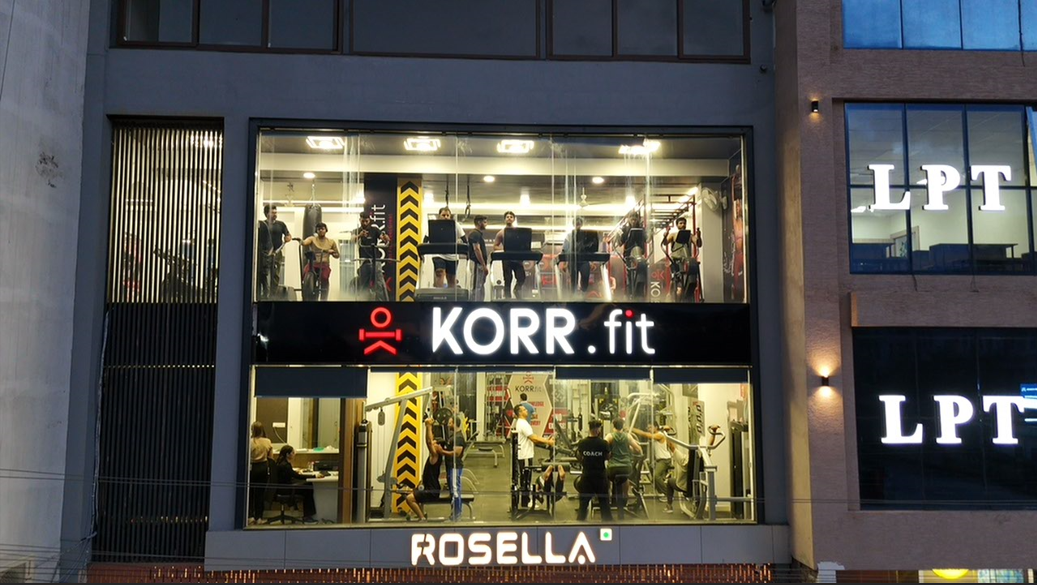 Night view of the KORR.fit gym floor with members training